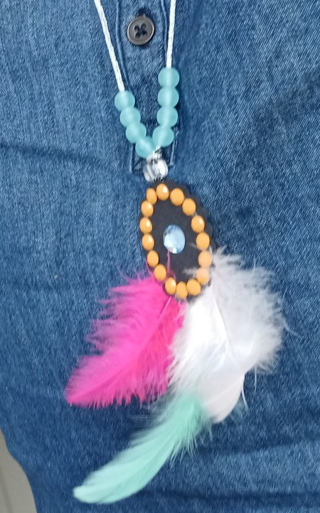 A completed feather pendant.