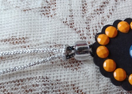 Attaching a cord to the pendant.