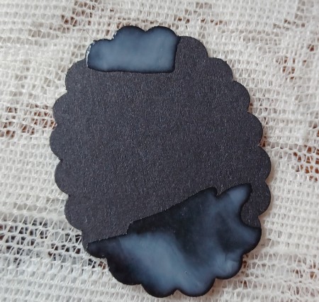 Adding glue to the top and bottom of the pendant.