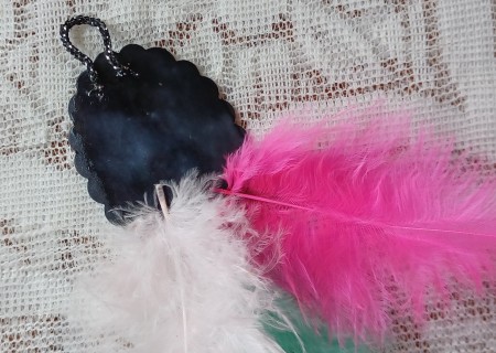 Adding feathers to the back of the pendant.