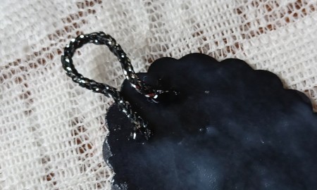 A loop on the back of the pendant.