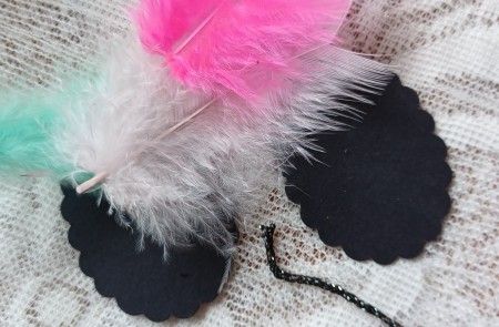 Attaching feathers to the pendants.