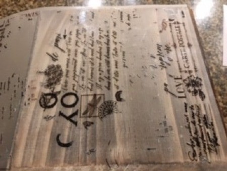 Rubbing the stencil words on the box.