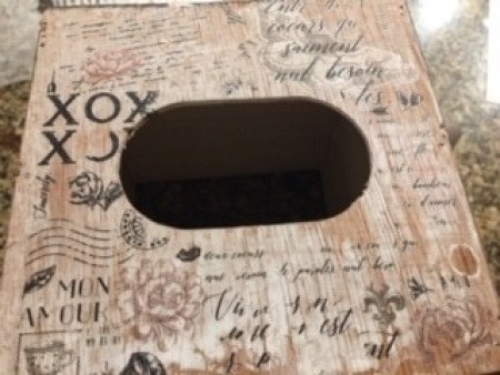 Rubbing the stencil words on the box.