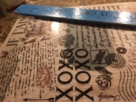 Rubbing the stencil words on the box.