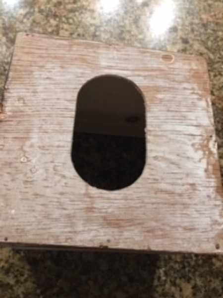 A hole cut into the top of the box.