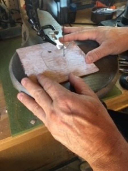 Cutting a hole in the top of a box.