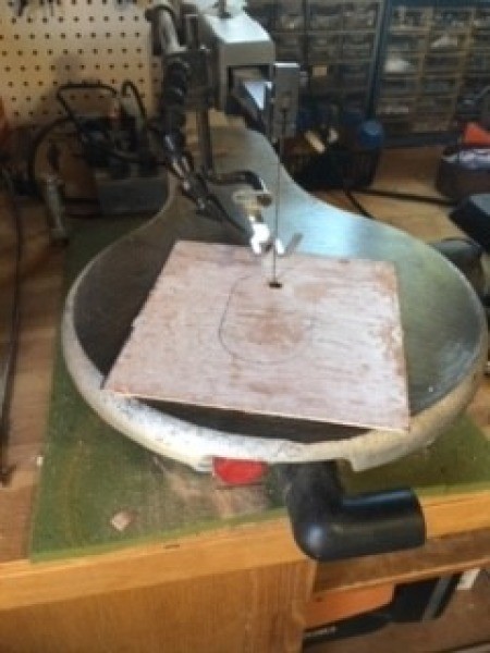 Cutting a hole in the top of a box.