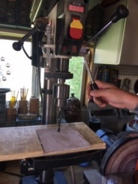 Cutting a hole in the top of a box.