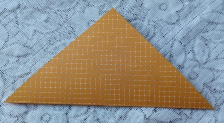 Folding the letter in half crosswise.