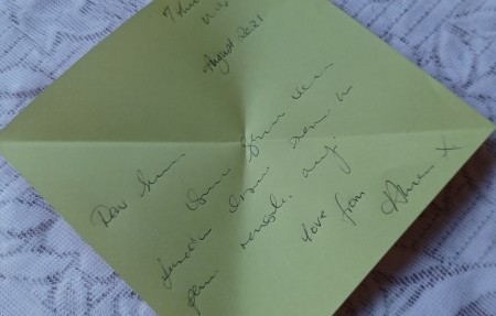 Unfolding the letter.