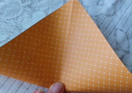 Folding the letter the other direction.