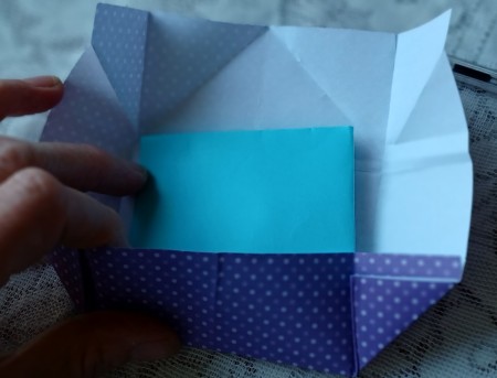 Adding the letter to the envelope.