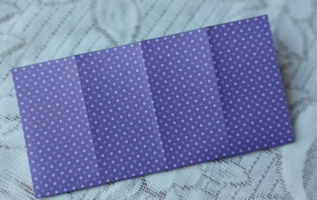 Refolding the paper in the opposite direction.