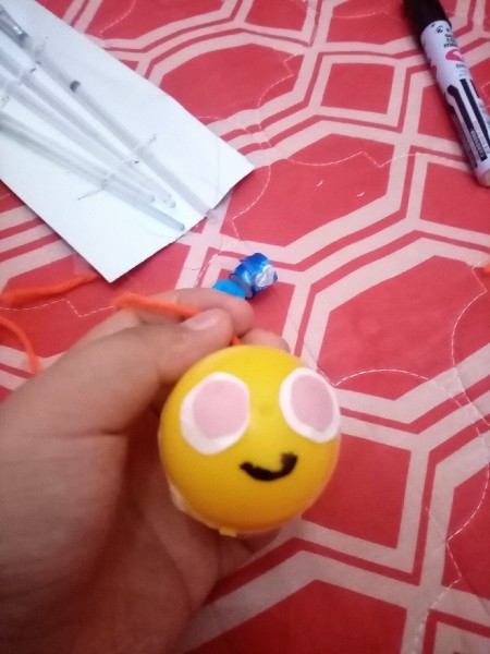 Adding a smile to the egg toy.