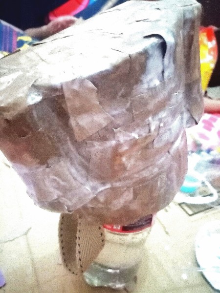 Covering the plastic with paper.