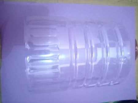 A large clear recycled bottle, cut in half.