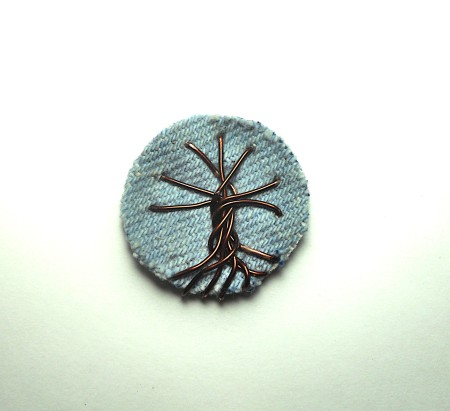 The tree shape on the denim circle.