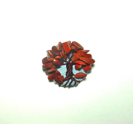 Adding beads to the tree as leaves.