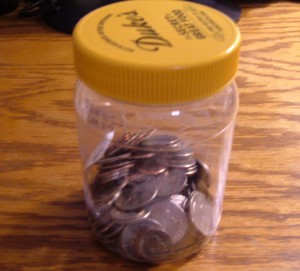 A recycled jar with change inside.