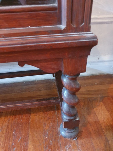 The leg of a wooden cabinet.