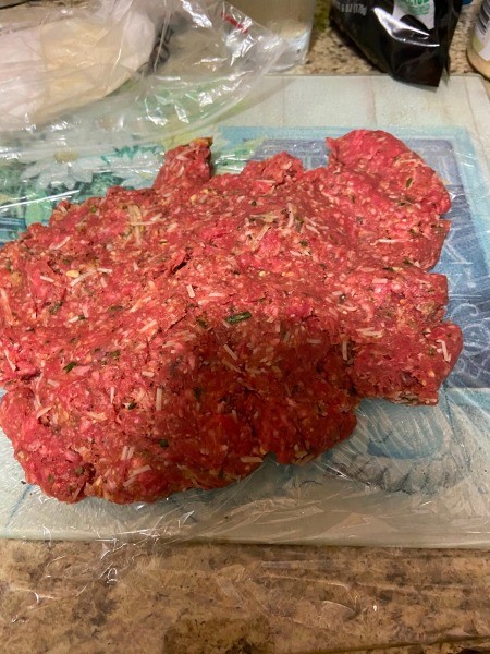 Placing the meatloaf mixture in a rectangular shape.