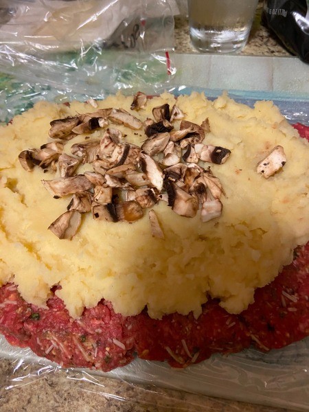 Adding mushrooms to the meatloaf.