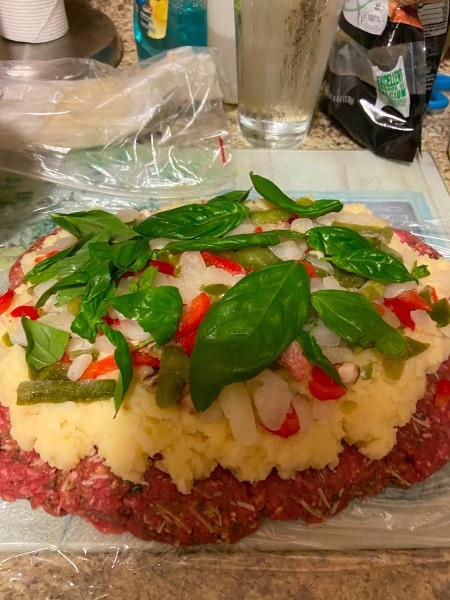 Adding basil to the meatloaf.