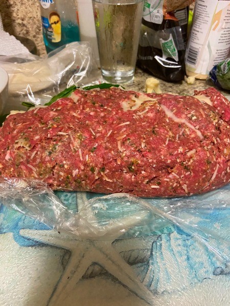 Rolling the stuffed meatloaf.