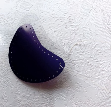 Sewing the paw print to the clear plastic.