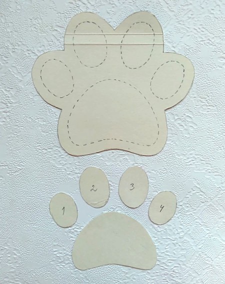 A template of a paw print with the pieces cut out.