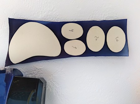 Tracing the paw template onto a piece of plastic.