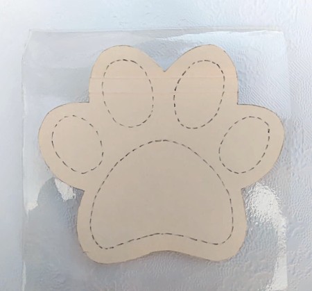 The paw pad template on clear plastic.