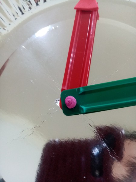 Attaching the hands to the center of the plate.