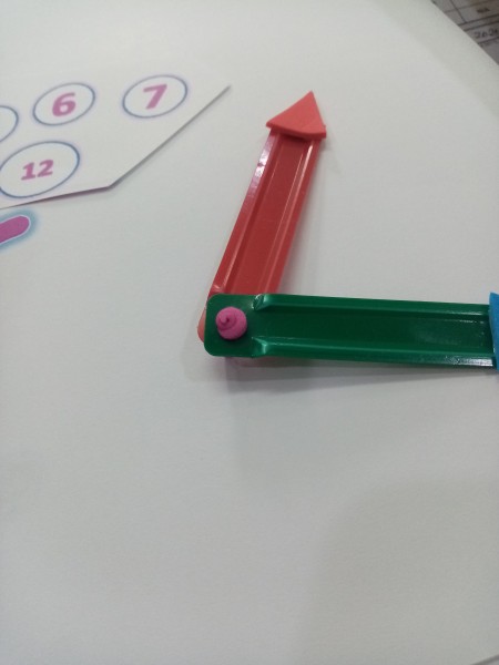 Attaching the clock hands together.