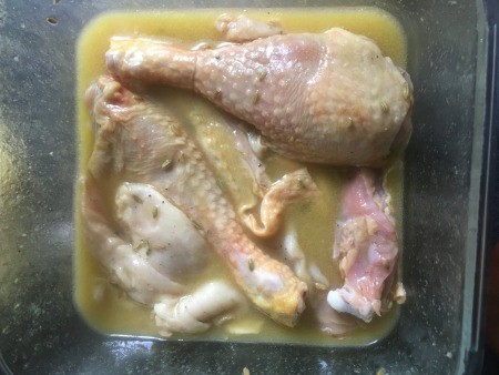 Marinating chicken in a pan.