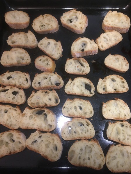 Placing bread on a baking sheet.