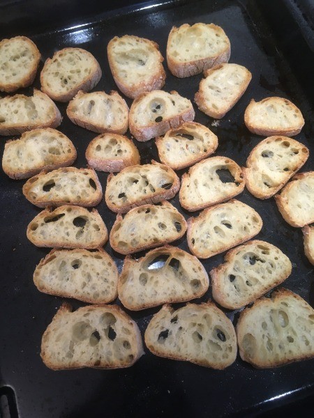 Placing bread on a baking sheet.Alcohol)