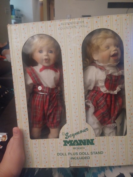 Two porcelain dolls of children on skates.