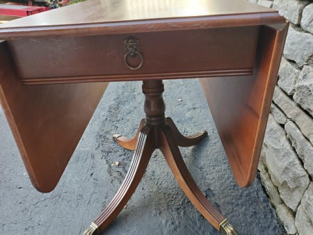 A wooden drop leaf table.