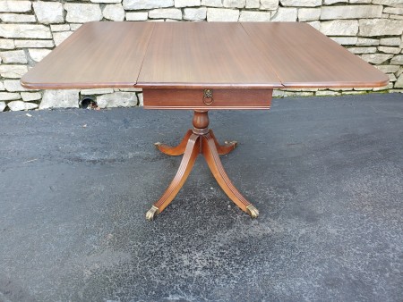 A wooden drop leaf table.