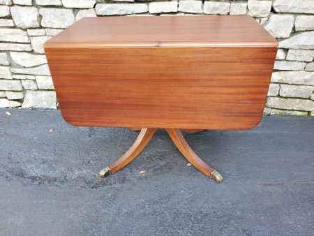 A wooden drop leaf table.