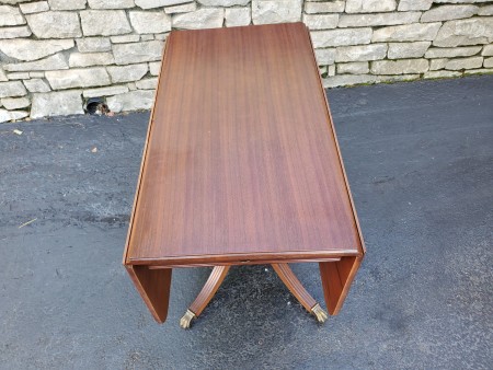 A wooden drop leaf table.