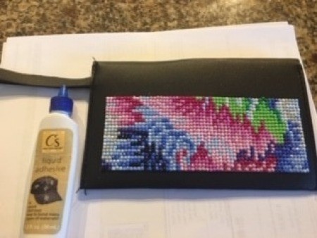 Gluing the diamond painting to a case.