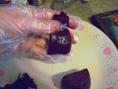 Moving the beets wearing gloves.