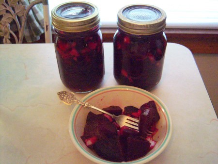 The canned beets and a bowl full of the pickled beets.