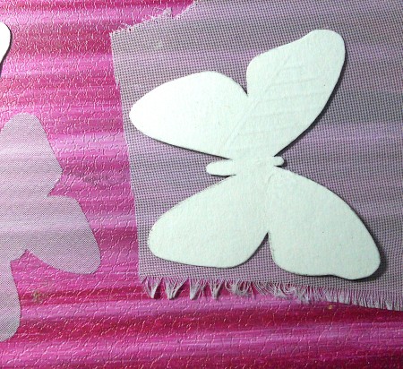 Tracing the butterfly outline on the fabric.