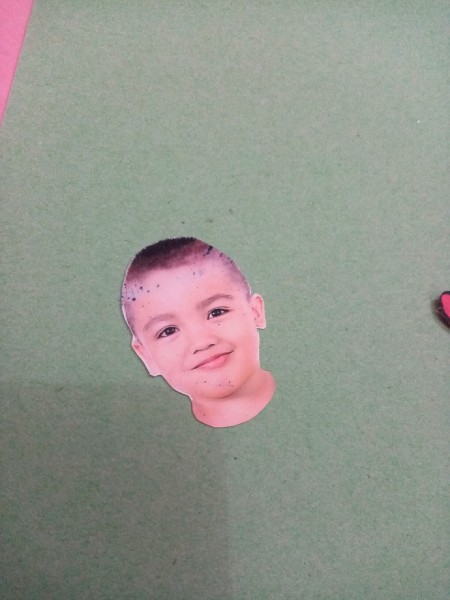 Cutting out a photo of a head.