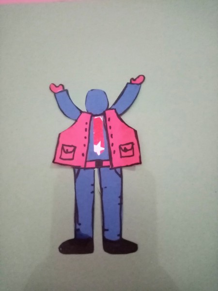 Decorating the paper figure with clothing.