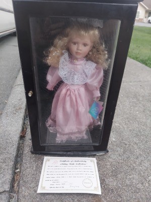 A porcelain doll in a decorative box.